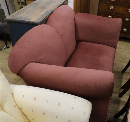 An Edwardian drop end camel back sofa W.130cm